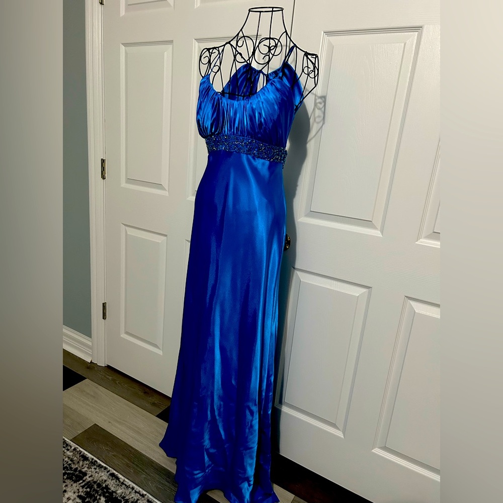 Cobalt blue floor length formal dress with bead accents.